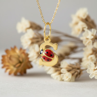 Pendentif initiale S et coccinelle, Or jaune 375 - Emanessence